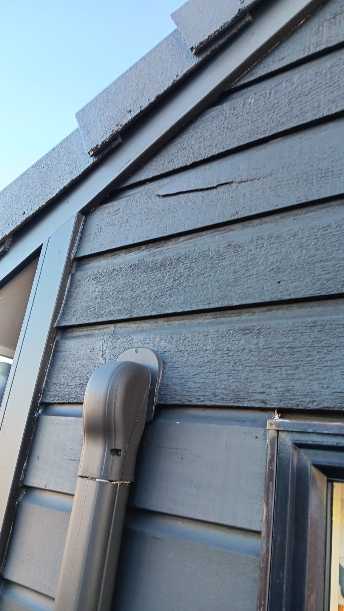 Weathered exterior weatherboards and vent junction